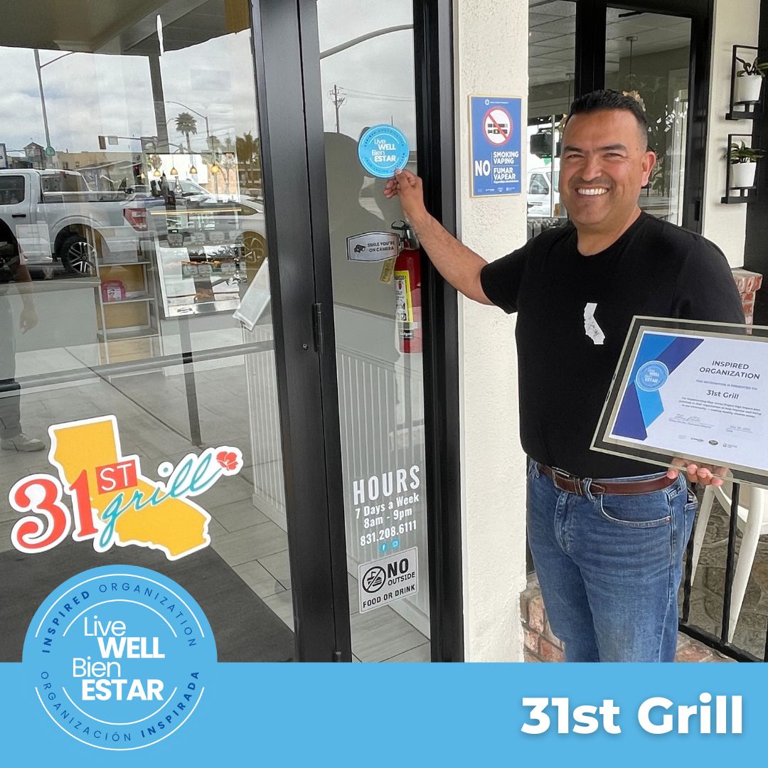 Eddie Estrada places Blue  Zone logo on 31st Grill door